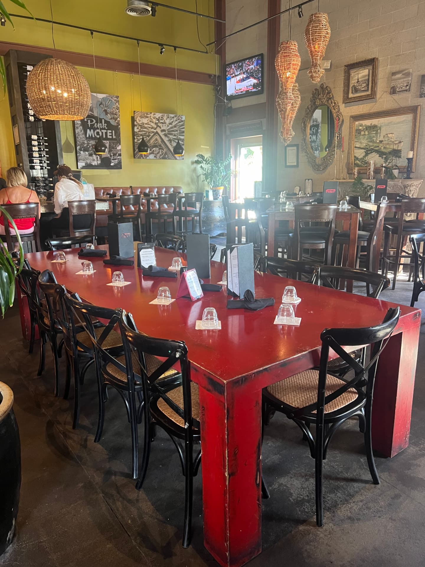 Inside Red Table restaurant in Huntington Harbour, featuring its signature red communal table